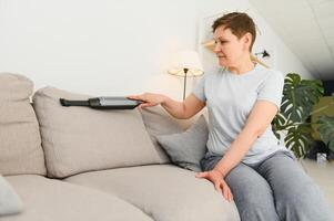 Middle-aged woman cleaning new apartment. photo