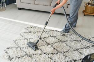 Cleaning concept. woman cleaning carpet with vacuum cleaner. photo