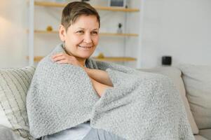 Portrait of a beautiful senior woman smiling at home. Old granny. photo