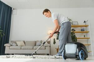 Cleaning concept. woman cleaning carpet with vacuum cleaner. photo