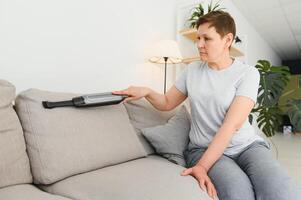 Middle-aged woman cleaning new apartment. photo