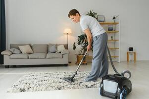 Cleaning concept. woman cleaning carpet with vacuum cleaner. photo