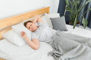 middle-aged woman sleeping in bed at home. photo
