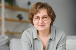 Close-up portrait of a happy older woman at home photo