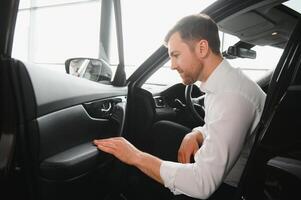 Man buying a car at a showroom photo