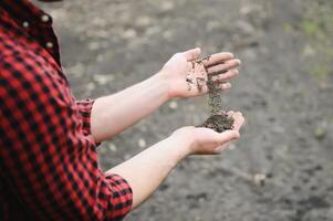 Soil in farmer arms. image with selective focus. photo