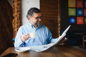 Business man reading a newspaper, cafe backgrounds photo