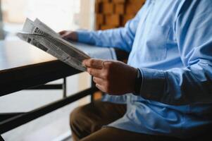 coffee break. man drinking coffee and reading newspaper in cafe bar photo