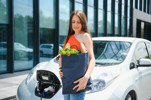 Woman is charging rental electric car photo