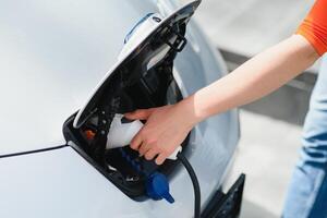 Woman is charging rental electric car photo