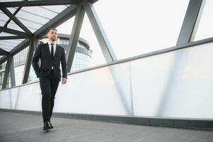 Handsome male model posing wearing a back suit. photo