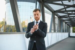 Handsome male model posing wearing a back suit. photo