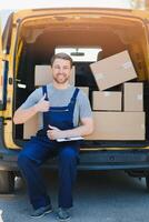 The courier brought the delivery of the box to the client. Courier service employee in uniform. photo