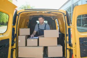 The courier brought the delivery of the box to the client. Courier service employee in uniform. photo