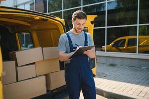 The courier brought the delivery of the box to the client. Courier service employee in uniform. photo