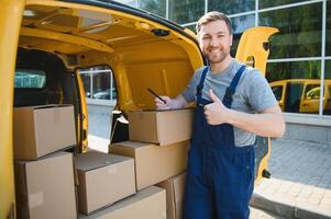 The courier brought the delivery of the box to the client. Courier service employee in uniform. photo