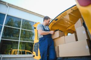 Delivery men unloading moving boxes from car photo