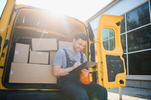 The courier brought the delivery of the box to the client. Courier service employee in uniform. photo