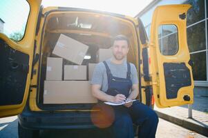 The courier brought the delivery of the box to the client. Courier service employee in uniform. photo