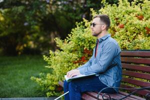 Blinded man reading by touching braille book photo