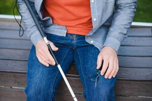 Blind man. People with disability, handicapped person and everyday life. Visually impaired man with walking stick. photo