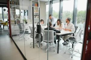 Corporate business team and manager in a meeting room at modern office with panoramic windows. Business concept photo