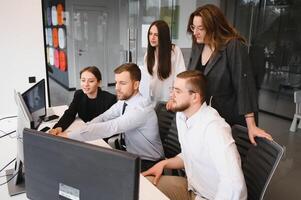 Group of businessmen and businesswomen stock brokers working at office. photo