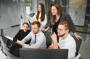 Group of businessmen and businesswomen stock brokers working at office. photo