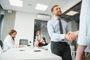 Smiling male business partners negotiators handshake start group office negotiation, company representatives welcoming shake hands at meeting getting acquainted expressing respect make financial deal photo