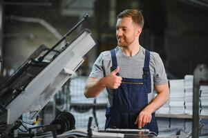 Man working in printing house with paper and paints photo