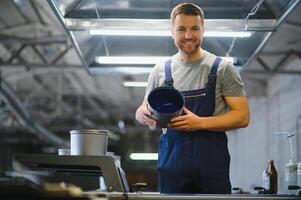 Man working in printing house with paper and paints photo