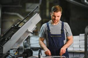 Factory worker. Man working on the production line. photo