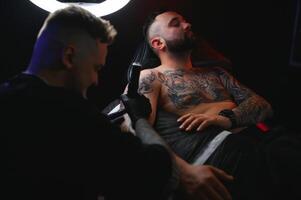 Professional tattoo artist makes a tattoo photo