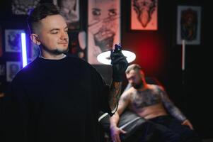 Portrait Of Tattoo Artist Standing Inside Parlor photo