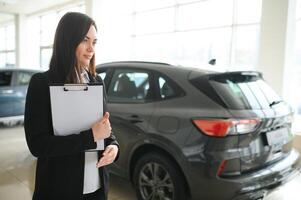 Salesperson selling cars at car dealership photo