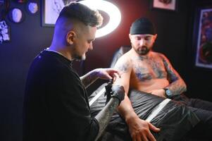 Professional tattoo artist makes a tattoo photo