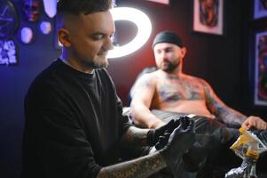 Professional tattoo artist makes a tattoo photo