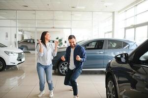 Excited Spouses Dancing In Dealership Office After Buying New Car photo