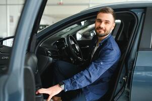 Man customer male buyer client chooses auto wants to buy new automobile photo