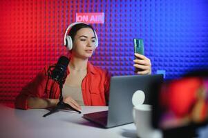 Young creative woman live streaming a for her followers on social media photo