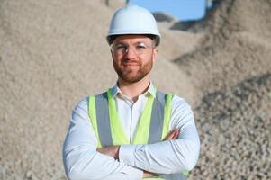 Engineer at the Crushed stone production plant. Gravel photo