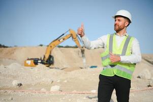 Male worker with bulldozer in sand quarry photo