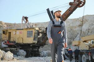 Male worker with bulldozer in sand quarry photo