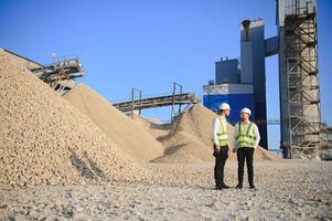 Two engineers at an industrial plant. Crushed stone production plant. Gravel photo