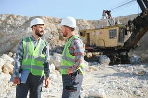 Two workers and quarry in background photo