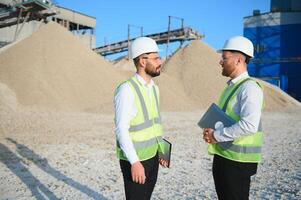 Two engineers at an industrial plant. Crushed stone production plant. Gravel photo