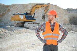 Male worker with bulldozer in sand quarry photo