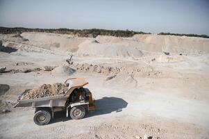 Large quarry dump truck. Big yellow mining truck at work site. quarry photo