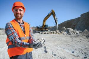 Male worker with bulldozer in sand quarry photo