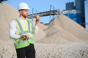 Engineer at the Crushed stone production plant. Gravel photo